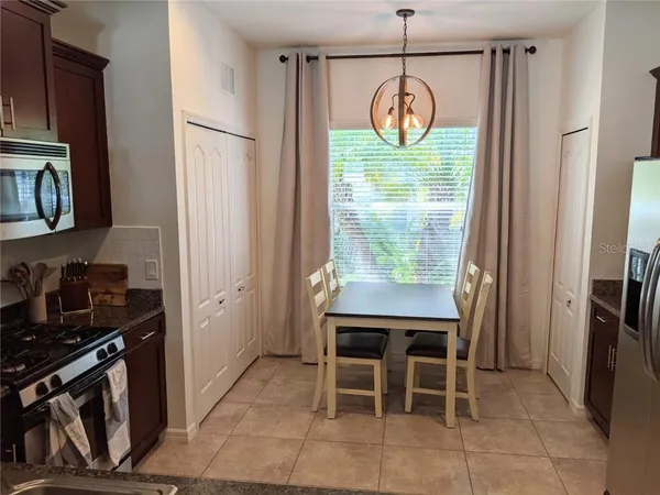 a room with stainless steel appliances granite countertop a stove and a refrigerator