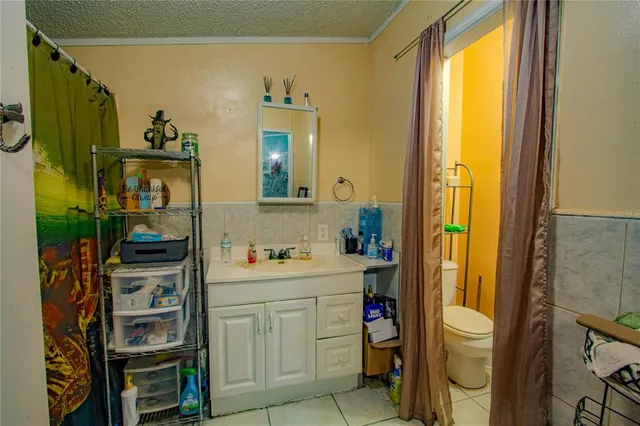 a bathroom with a sink a toilet and a shower