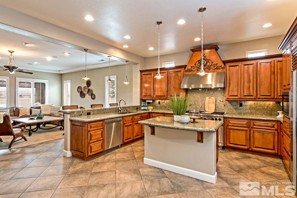 10125 Burghley Lane Reno, NV 89521 - Photo 4 of 13 a kitchen with stainless steel appliances granite countertop lots of counter top space
