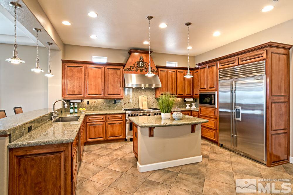 10125 Burghley Lane Reno, NV 89521 - Photo 5 of 13 a kitchen with a sink stove and refrigerator