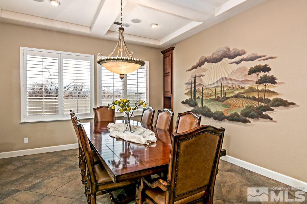10125 Burghley Lane Reno, NV 89521 - Photo 7 of 13 a dining room with furniture a chandelier and wooden floor
