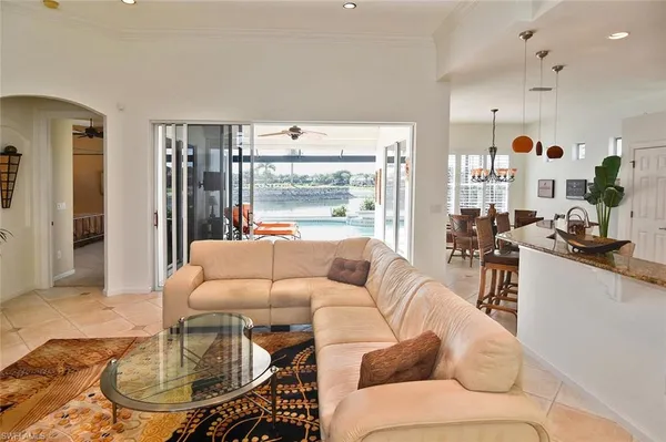a dining room with furniture a chandelier and wooden floor