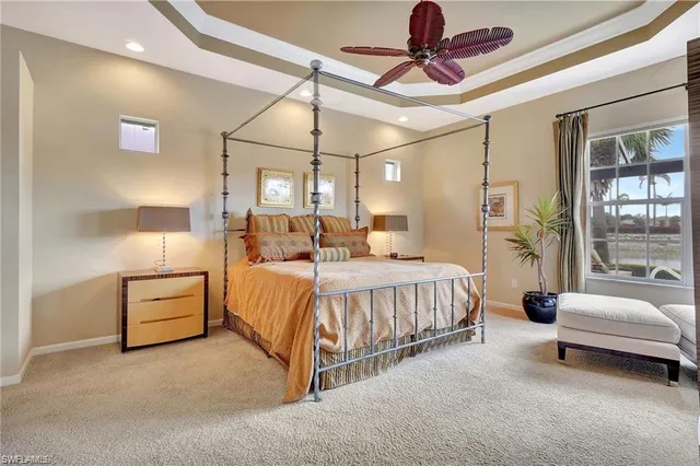 a spacious bedroom with a bed and a chandelier