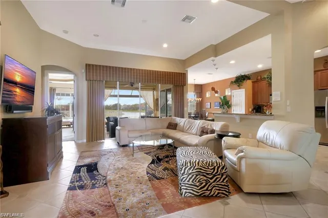 a living room with furniture wooden floor and a flat screen tv