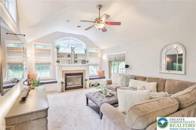 a view of a bedroom with wooden floor and windows