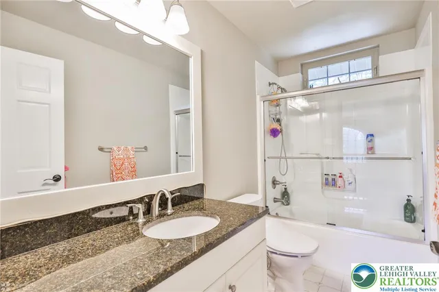 a living room with stainless steel appliances furniture and kitchen view