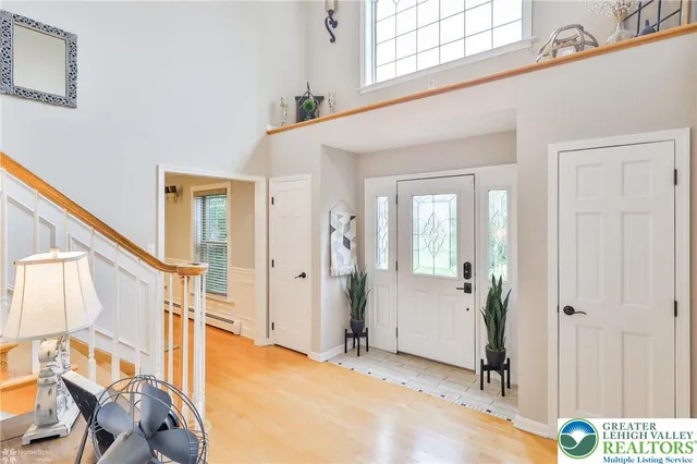 a view of an entryway with wooden floor and door