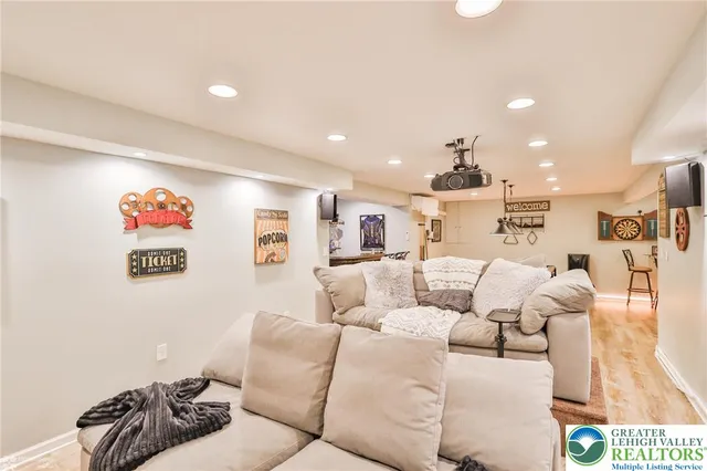 a living room with furniture tv and a large window