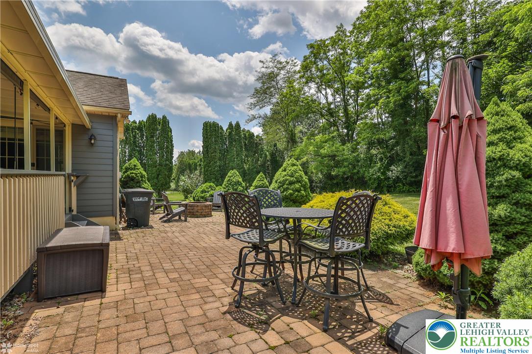 1147 Jacobsburg Road Wind Gap, PA 18091 - Photo 54 of 70 a view of a patio with a table and chairs