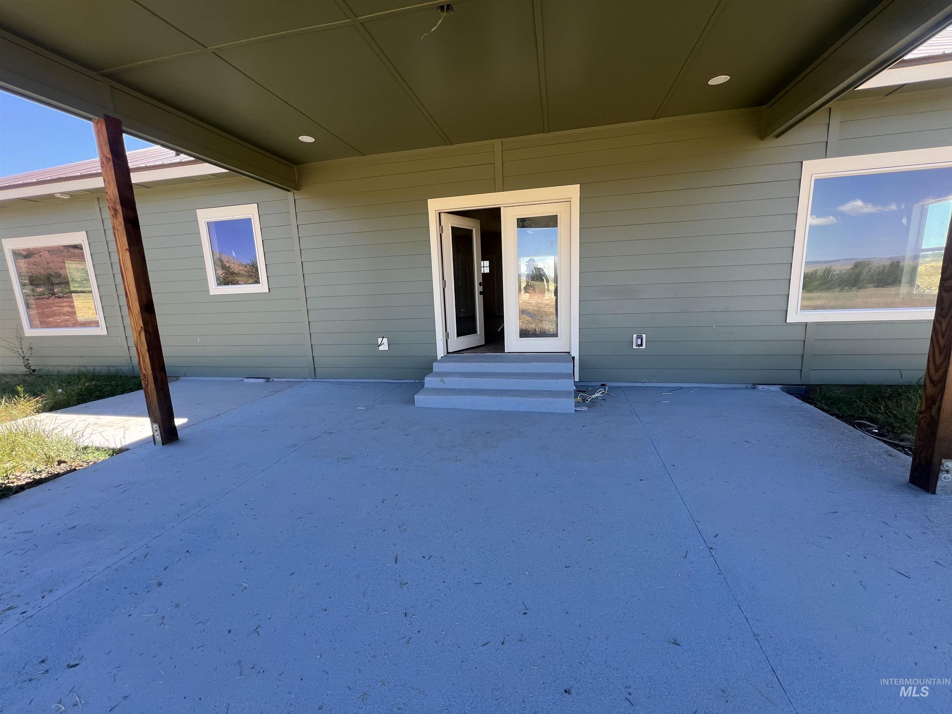 2300 Golf Council, ID 83612 - Photo 10 of 17 Covered concrete patio with recessed lighting, green siding exterior, and white-framed windows