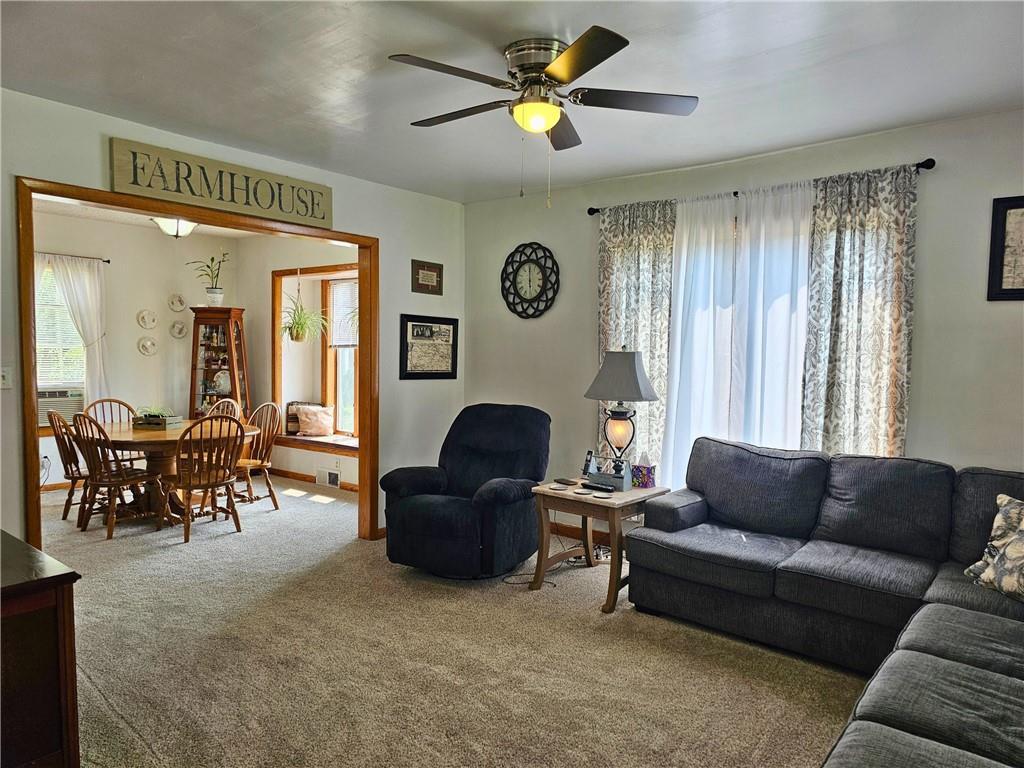 685 South Keel Ridge Road Hermitage, PA 16148 - Photo 13 of 42 a living room with furniture a chandelier and a large window