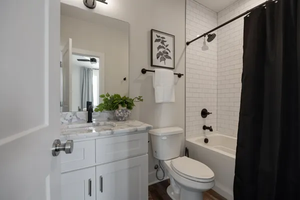 a bathroom with a toilet sink shower and mirror