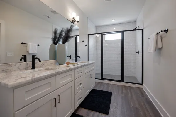 a spacious bathroom with a double vanity sink and mirror