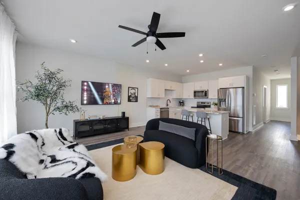a living room with furniture and kitchen view