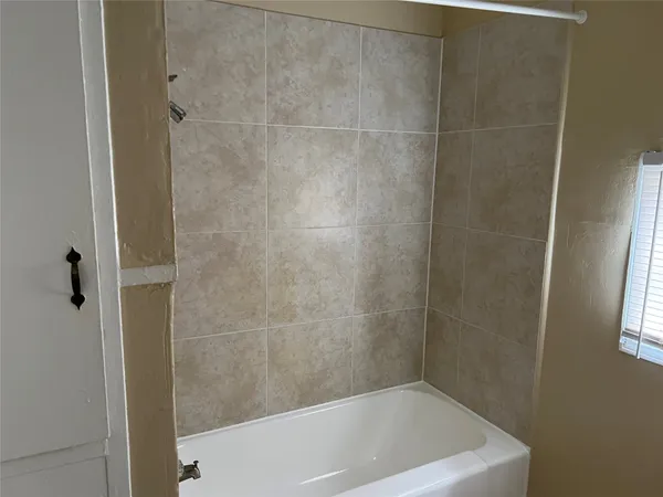 a bath tub sitting next to a shower