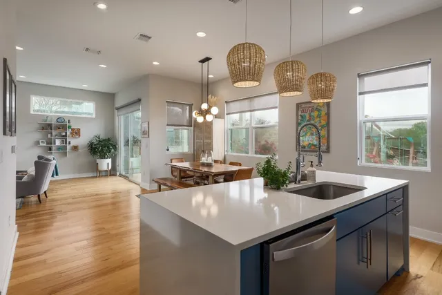 a kitchen with counter top space and living room