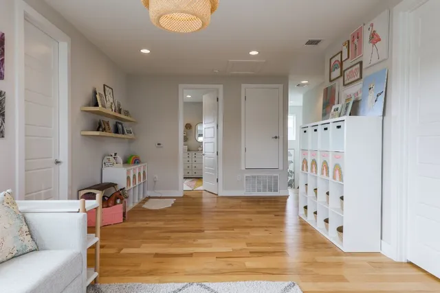 a living room with furniture and wooden floor