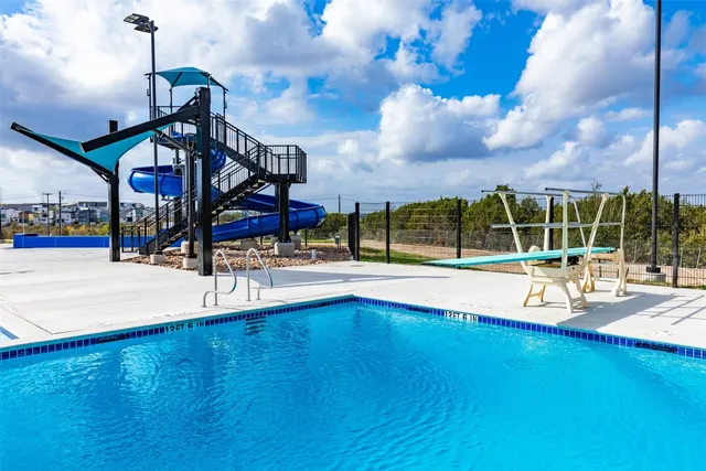 a view of a swimming pool with an outdoor space and seating area