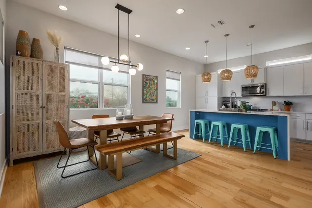a living room with furniture a flat screen tv and kitchen view