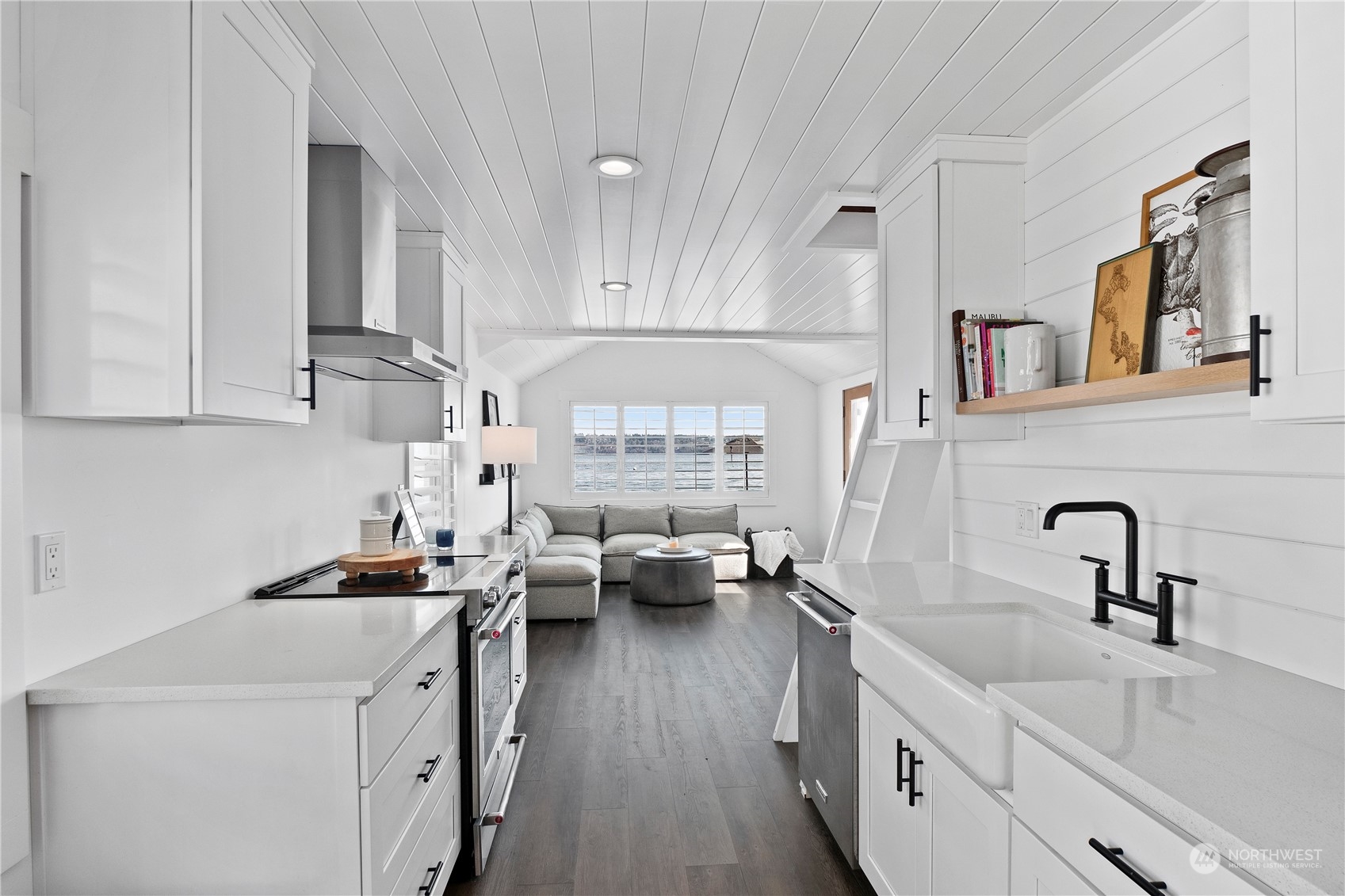 8003 Possession Beach Walk Clinton, WA 98236 - Photo 12 of 31 a kitchen with a sink dishwasher a stove and white cabinets with wooden floor