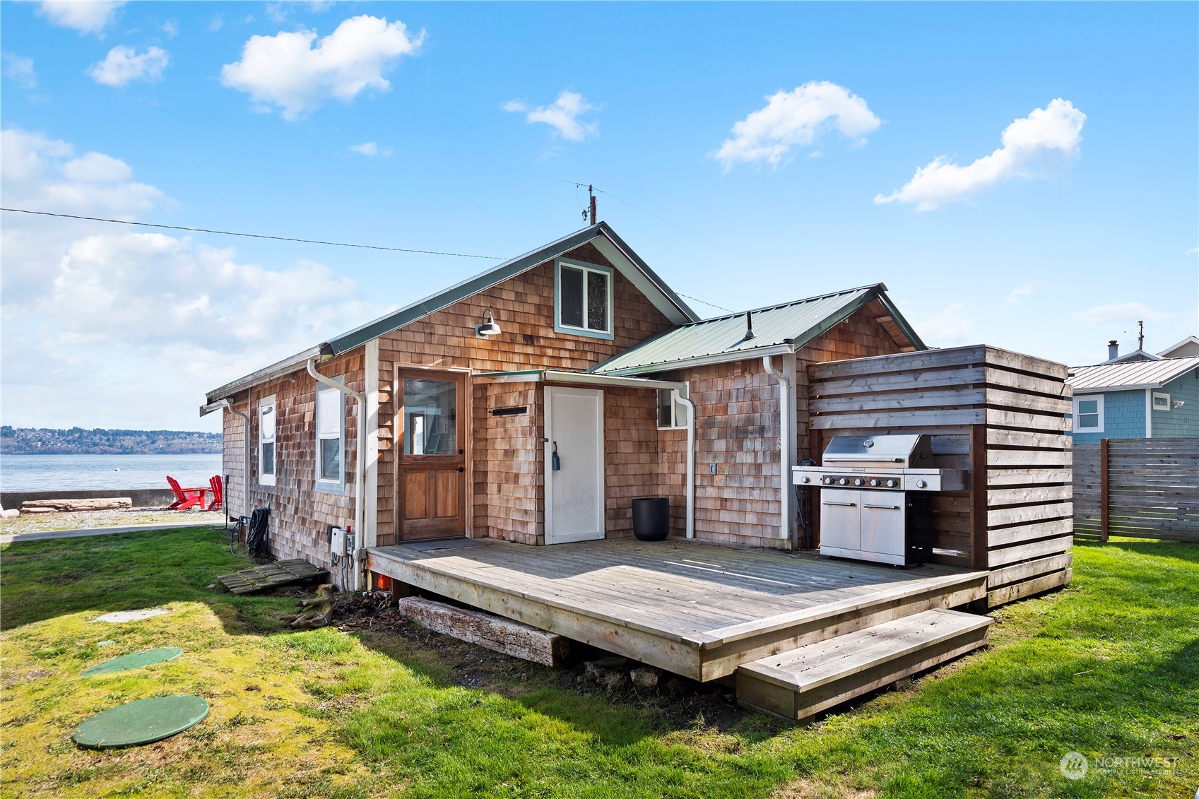 8003 Possession Beach Walk Clinton, WA 98236 - Photo 18 of 31 a front view of house with yard outdoor seating and barbeque oven