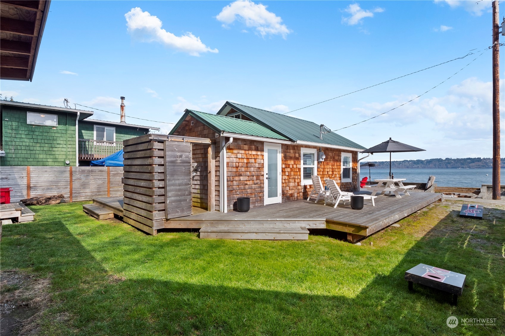 8003 Possession Beach Walk Clinton, WA 98236 - Photo 19 of 31 a view of a house with backyard porch and patio