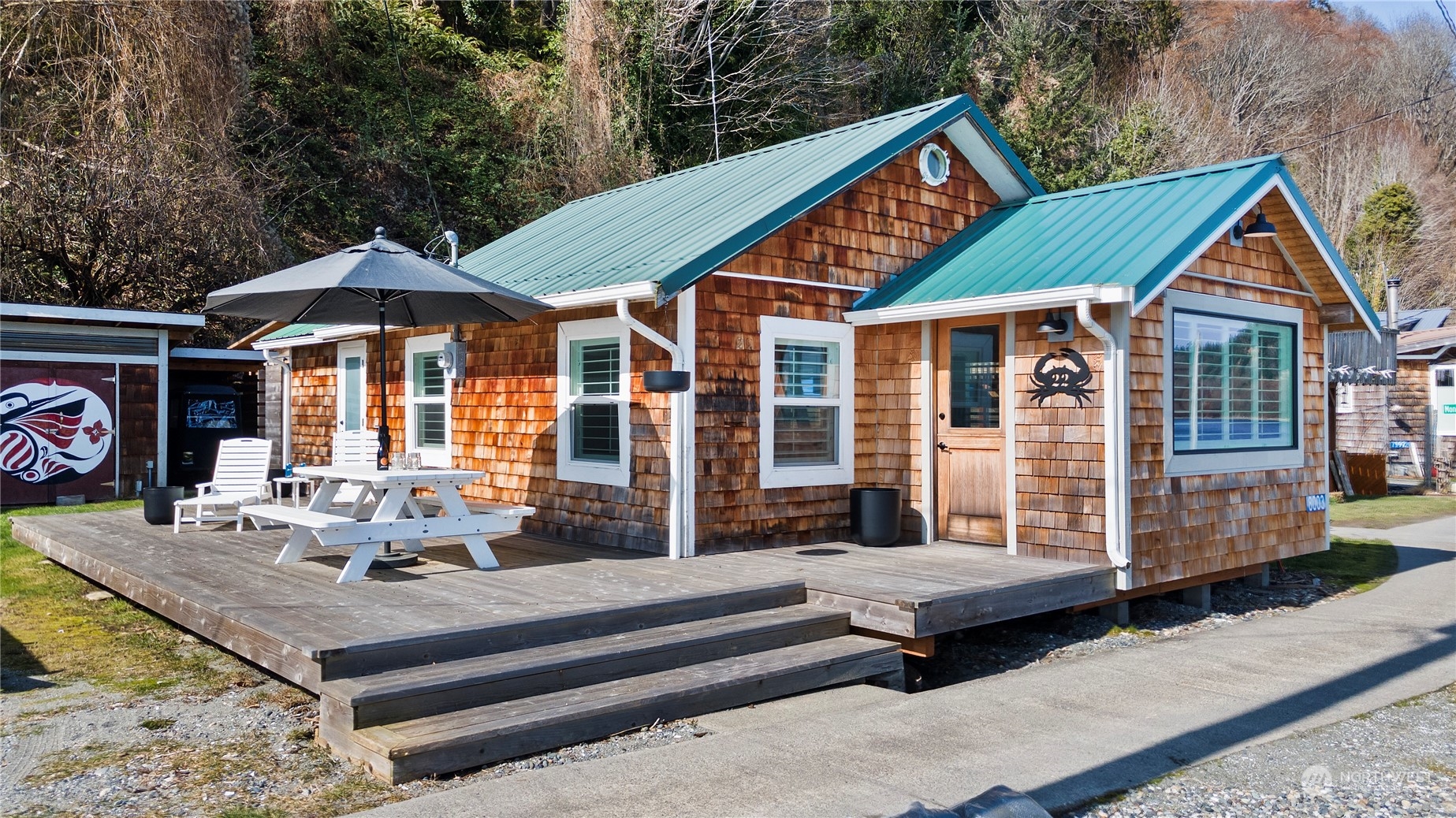 8003 Possession Beach Walk Clinton, WA 98236 - Photo 6 of 31 a front view of a house with porch
