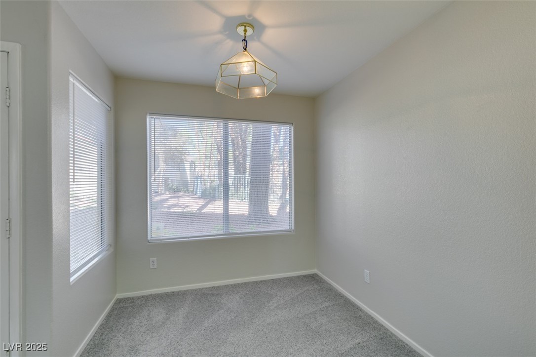 5211 Caspian Springs Drive, Unit 101 Las Vegas, NV 89120 - Photo 17 of 37 Unfurnished dining area featuring light colored carpet and baseboards