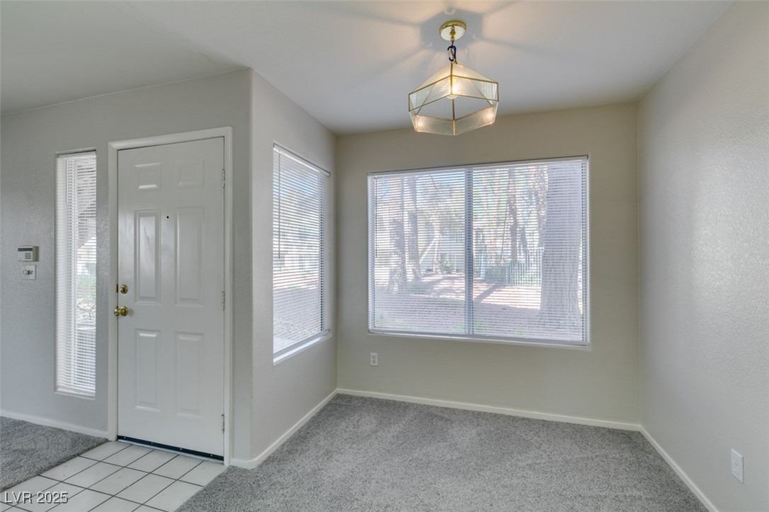 5211 Caspian Springs Drive, Unit 101 Las Vegas, NV 89120 - Photo 18 of 37 Entrance foyer featuring light carpet and light tile patterned floors