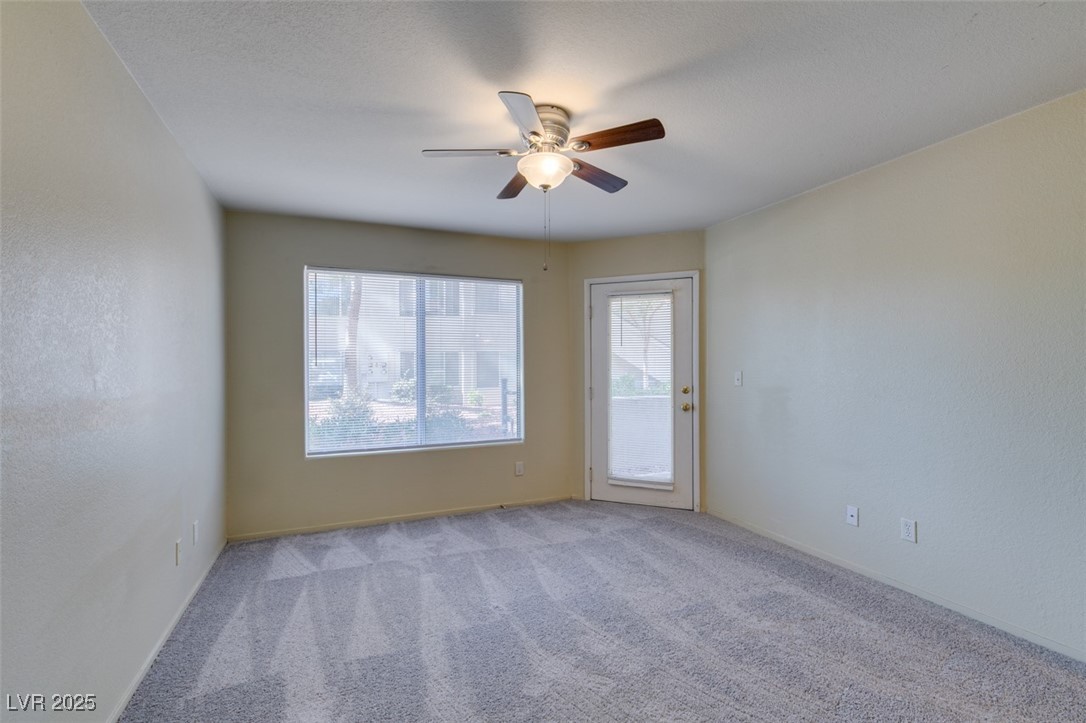 5211 Caspian Springs Drive, Unit 101 Las Vegas, NV 89120 - Photo 29 of 37 Carpeted empty room featuring a ceiling fan and a textured wall