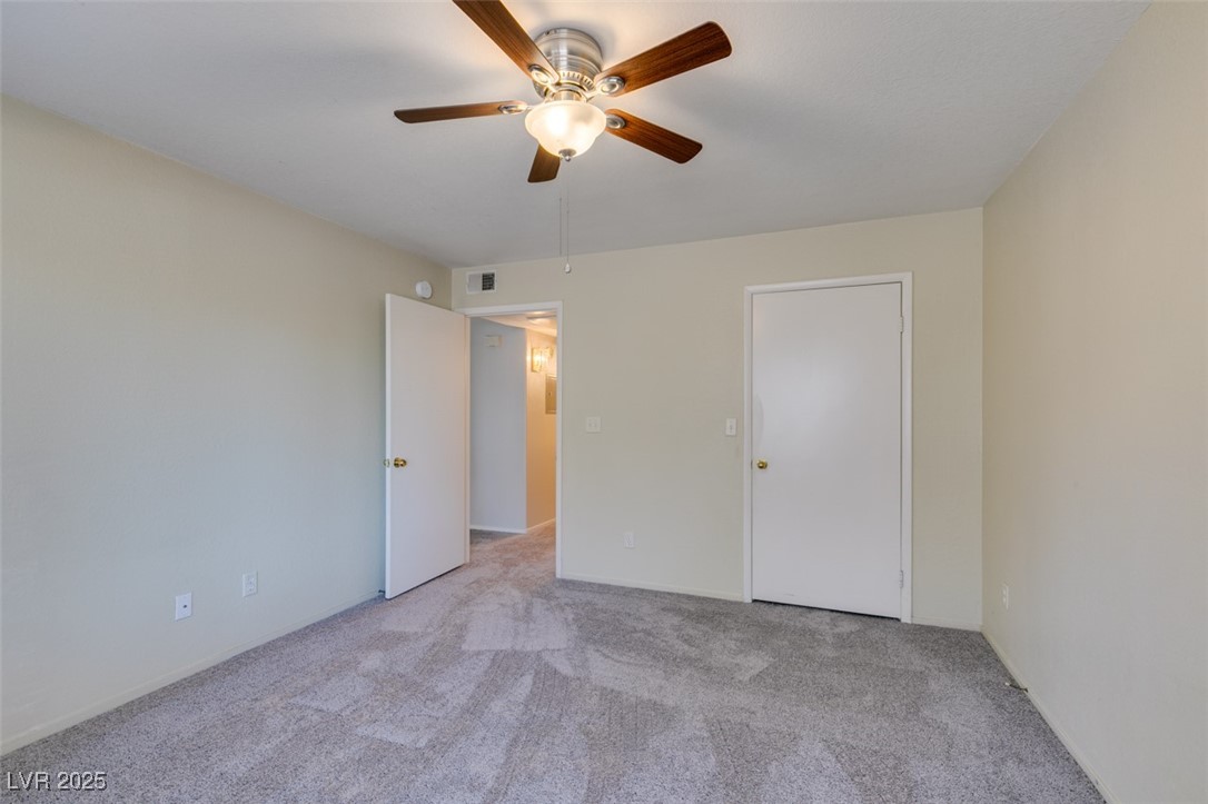5211 Caspian Springs Drive, Unit 101 Las Vegas, NV 89120 - Photo 31 of 37 Unfurnished bedroom with light carpet and a ceiling fan