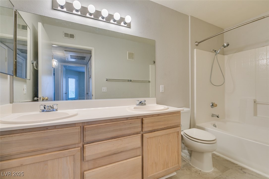 5211 Caspian Springs Drive, Unit 101 Las Vegas, NV 89120 - Photo 32 of 37 Full bath with double vanity and bathtub / shower combination