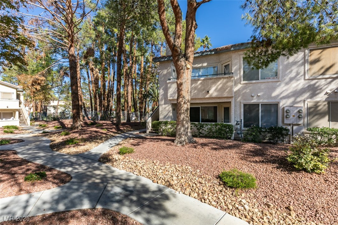5211 Caspian Springs Drive, Unit 101 Las Vegas, NV 89120 - Photo 4 of 37 View of front facade with stucco siding and stairs