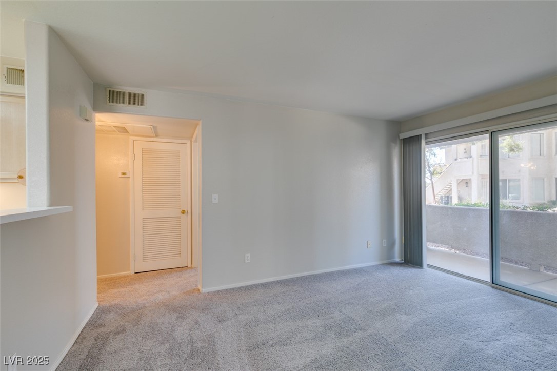 5211 Caspian Springs Drive, Unit 101 Las Vegas, NV 89120 - Photo 5 of 37 Unfurnished room with carpet floors and baseboards