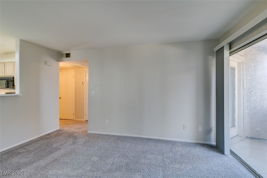 5211 Caspian Springs Drive, Unit 101 Las Vegas, NV 89120 - Photo 8 of 37 Unfurnished room with light colored carpet and baseboards
