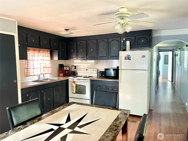 a kitchen with stainless steel appliances granite countertop a refrigerator sink and cabinets