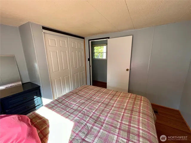 a bedroom with a bed and a mirror