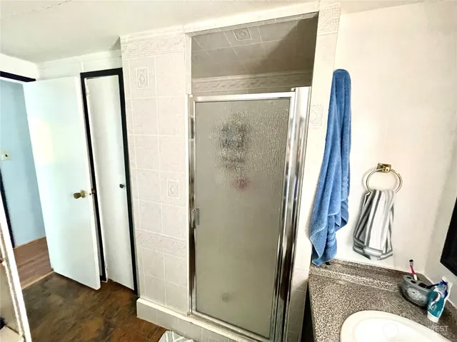 a bathroom with a shower and a mirror