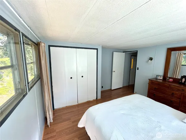 a bedroom with a bed and a dresser
