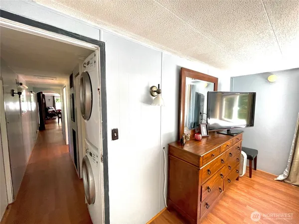 a view of a hallway with workspace and living room