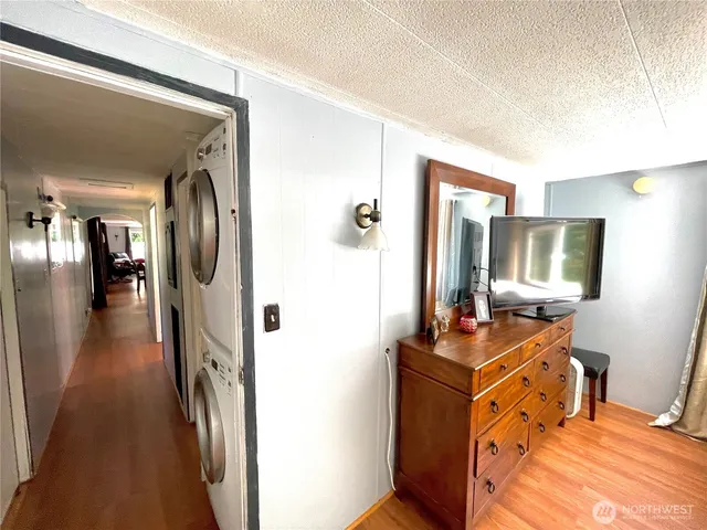 a view of a hallway with workspace and living room