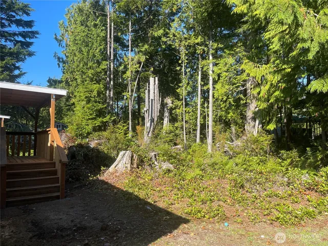 a yellow building with trees in the background
