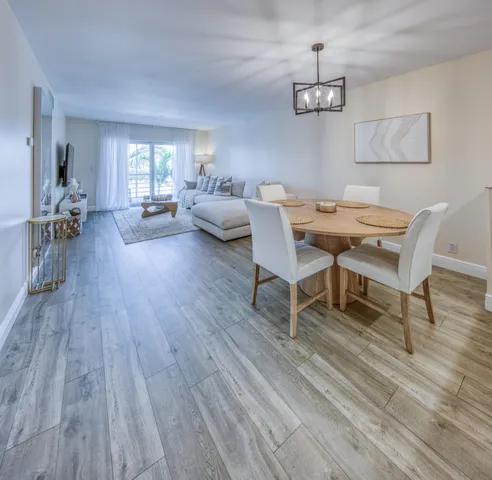 a living room with furniture dining table and wooden floor