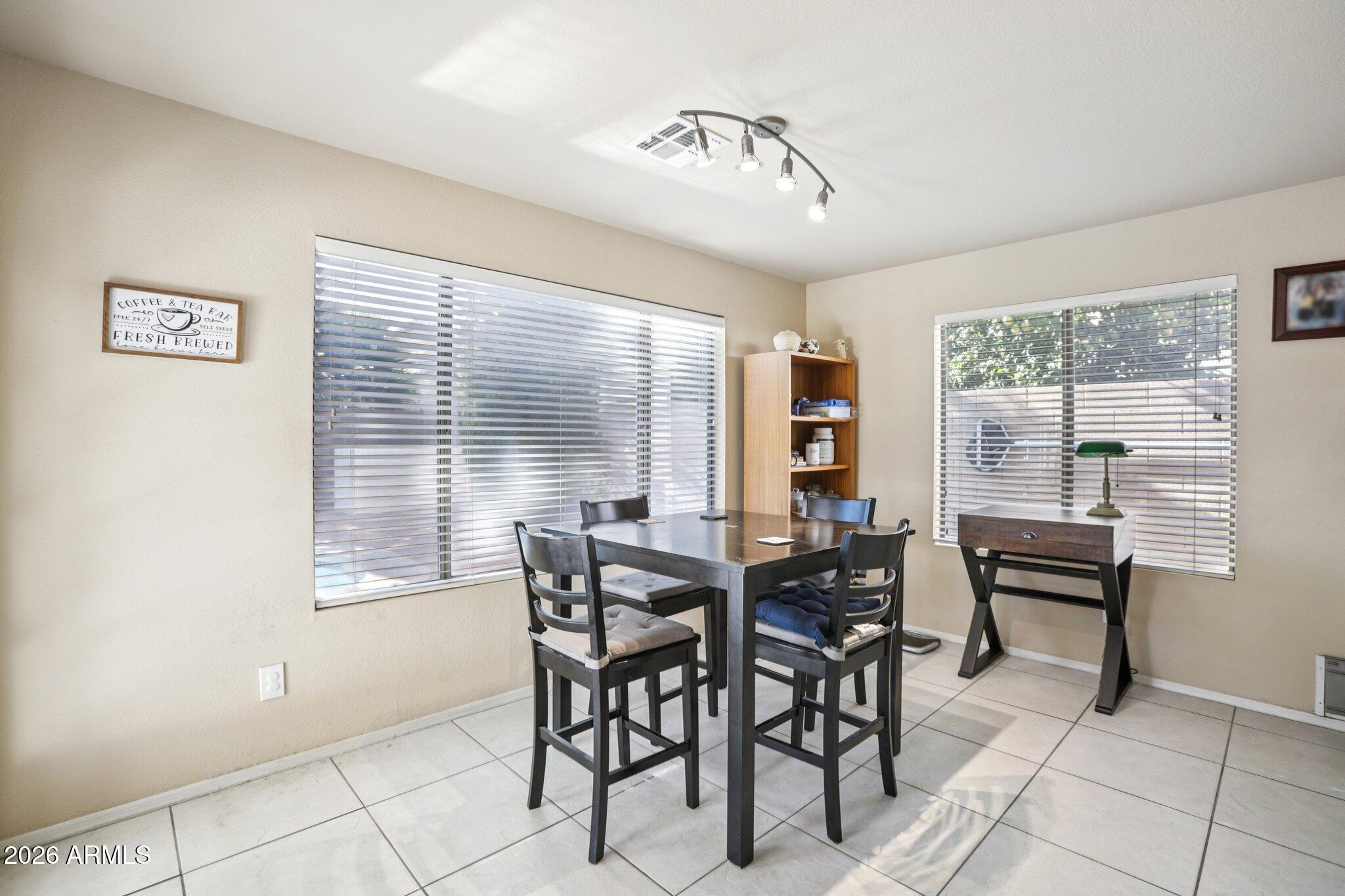 13414 South 47th Way Phoenix, AZ 85044 - Photo 8 of 32 a view of a dining room with furniture and window