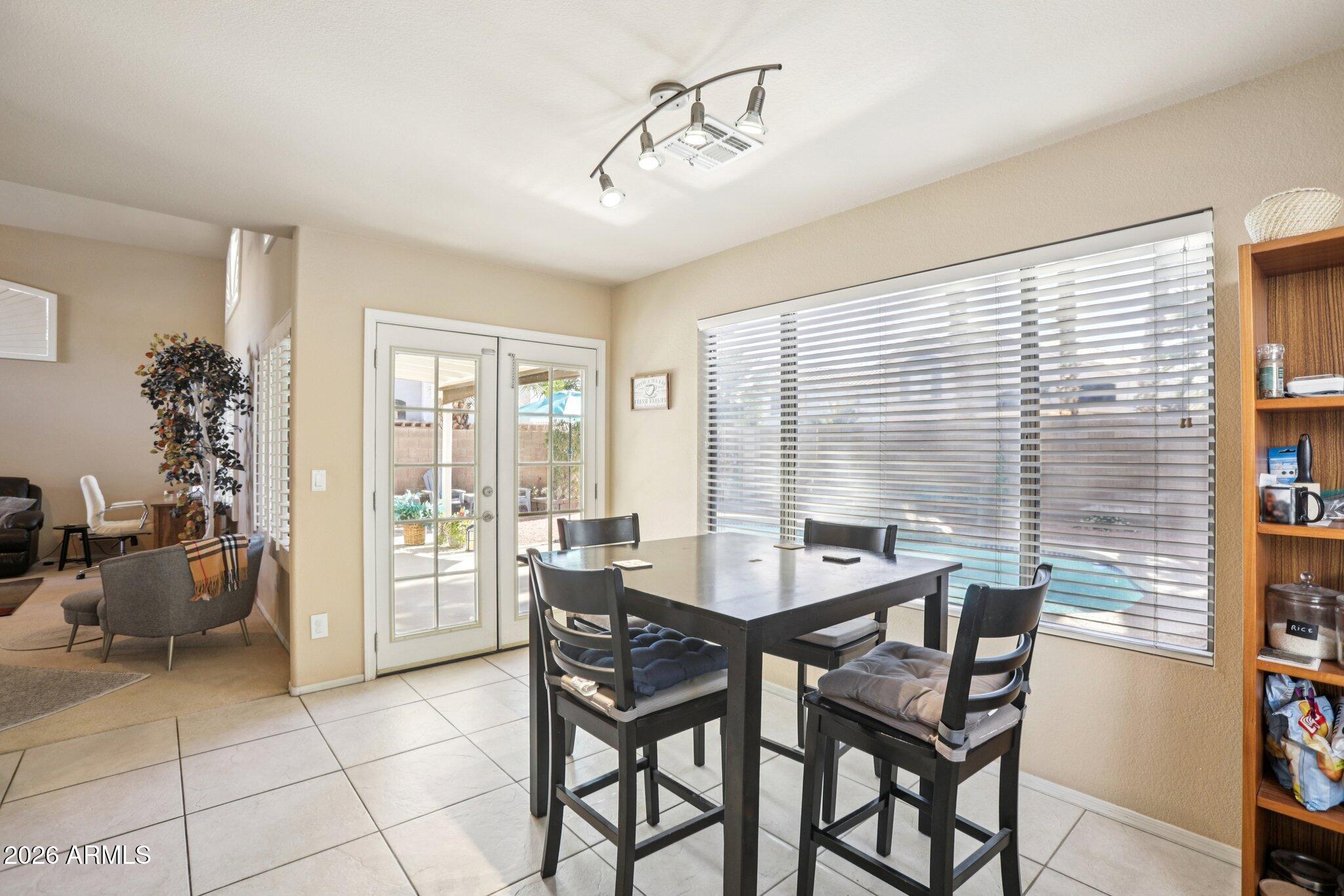 13414 South 47th Way Phoenix, AZ 85044 - Photo 9 of 32 a view of a dining room with furniture and a window