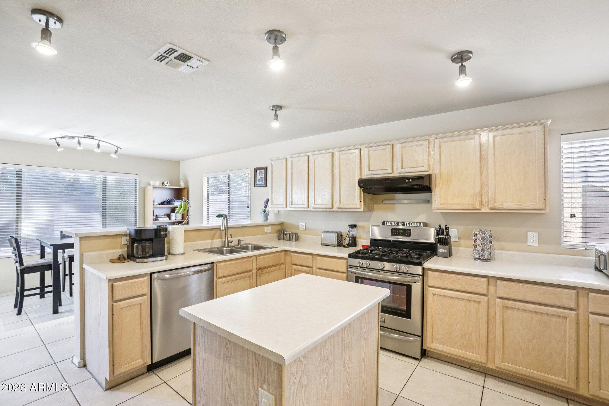 13414 South 47th Way Phoenix, AZ 85044 - Photo 11 of 32 a kitchen with white cabinets sink and white appliances