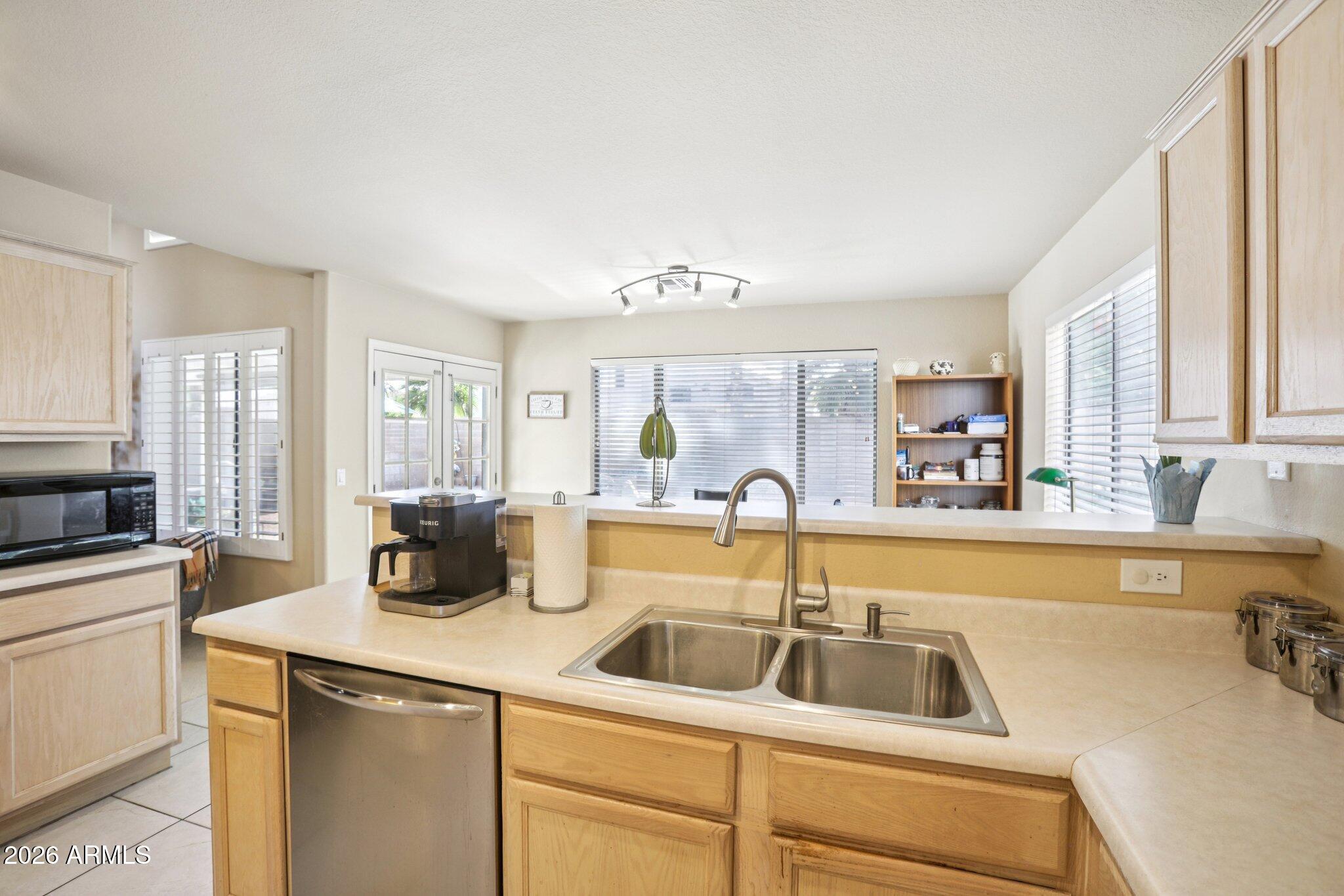 13414 South 47th Way Phoenix, AZ 85044 - Photo 13 of 32 a kitchen with sink a refrigerator and cabinets