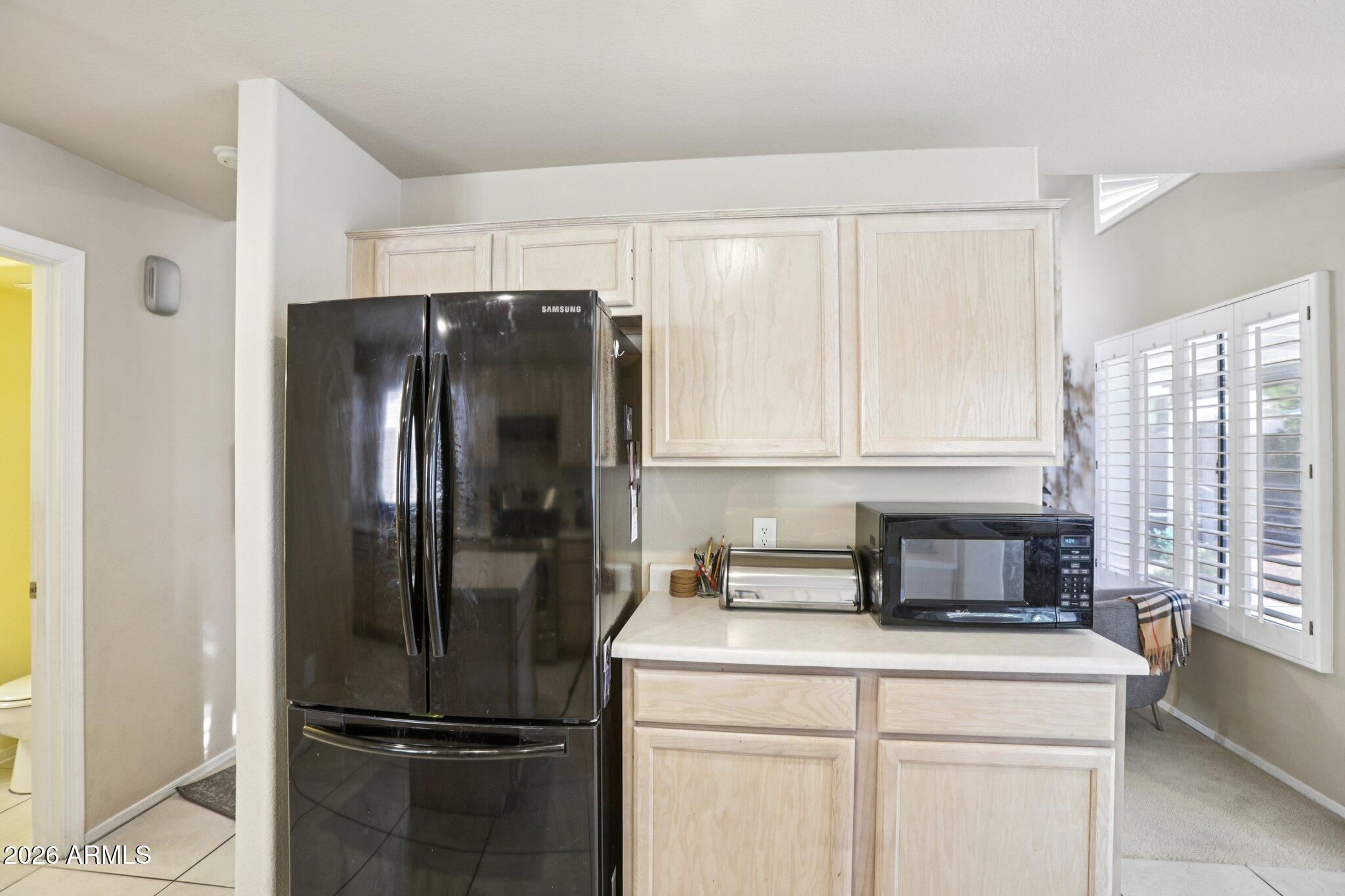 13414 South 47th Way Phoenix, AZ 85044 - Photo 14 of 32 a kitchen with a refrigerator sink and cabinets