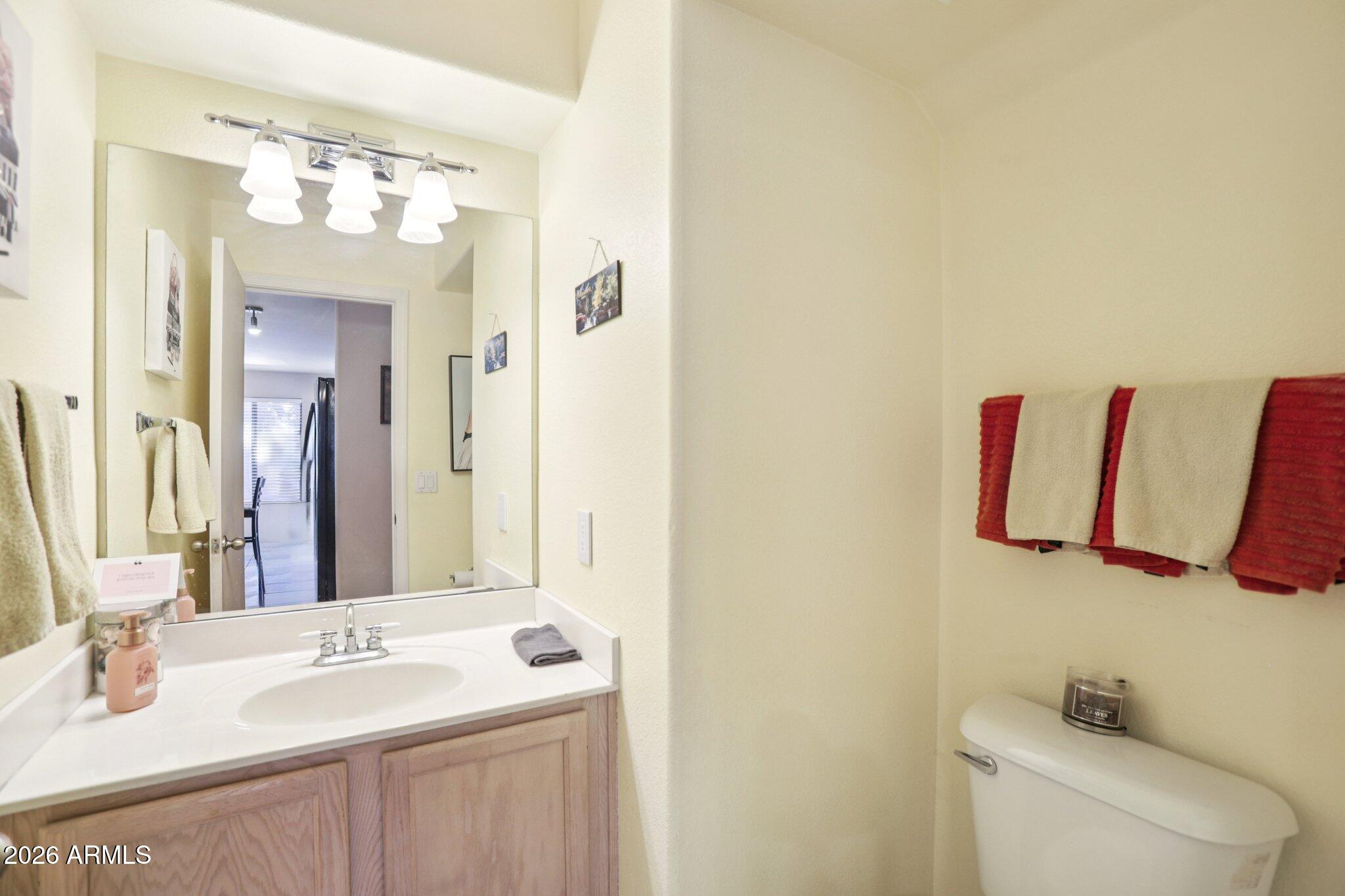13414 South 47th Way Phoenix, AZ 85044 - Photo 15 of 32 a bathroom with a sink vanity mirror and toilet
