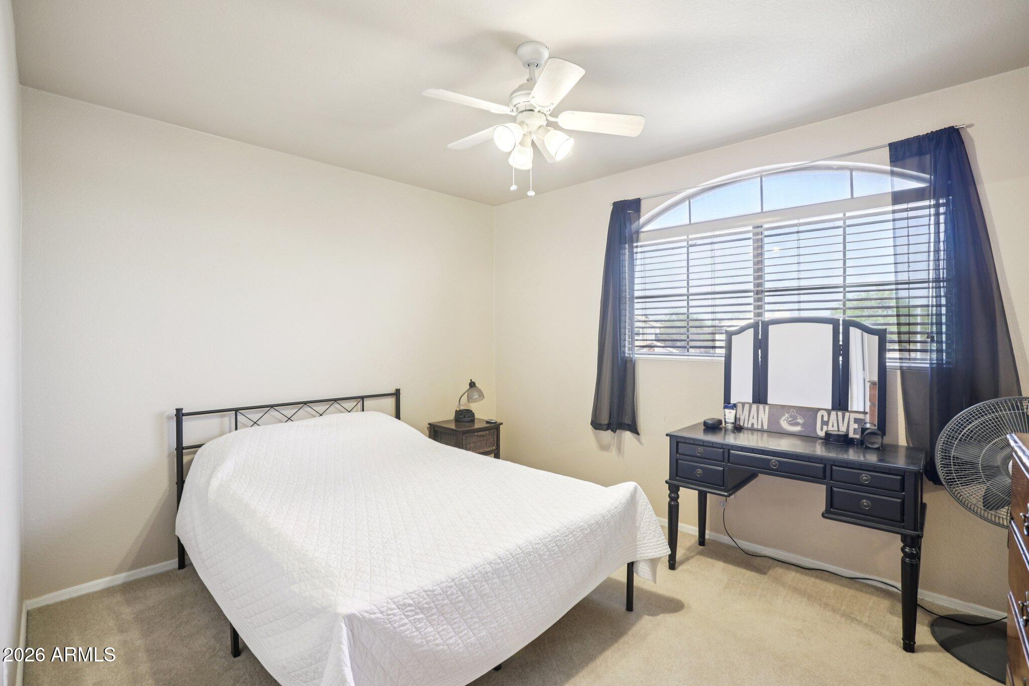 13414 South 47th Way Phoenix, AZ 85044 - Photo 18 of 32 a bedroom with a bed table and chair